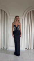 Black rhinestone embellished notched bodice floor-length evening maxi dress front view on model