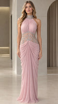 Front view of model wearing Blush Pink halter maxi evening gown with rhinestone waist