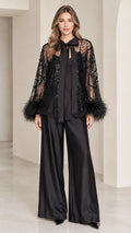 Model wearing black beaded overlay bow top and wide-leg satin pants front view
