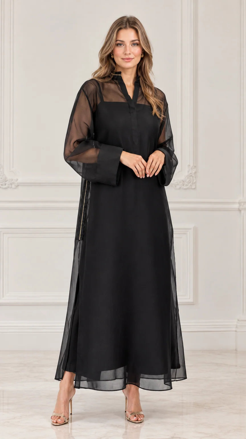 Front view of model wearing black sheer overlay maxi dress with long sleeves