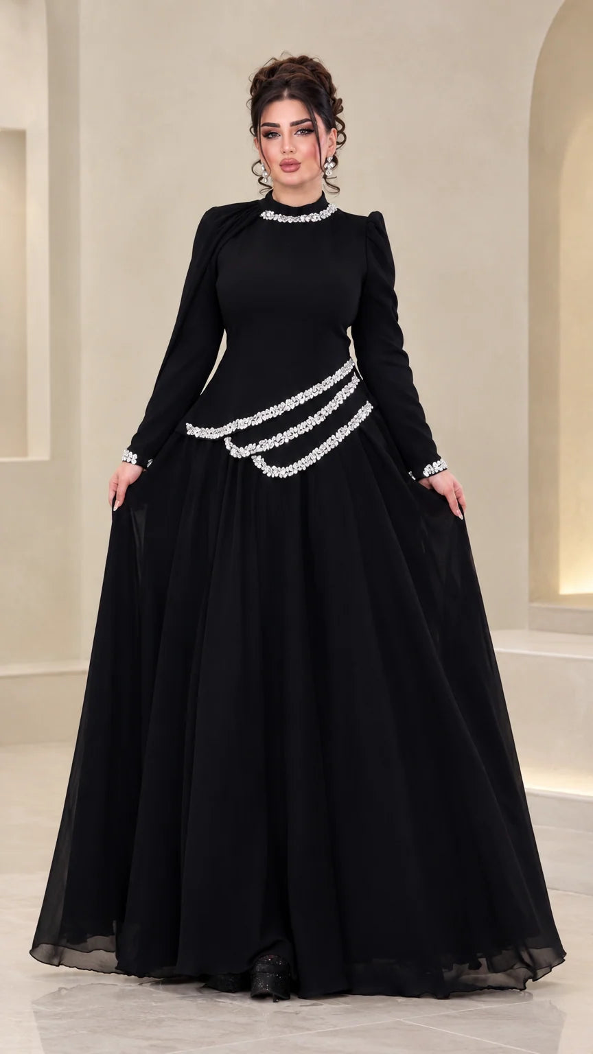 Front view of model wearing black rhinestone long sleeve chiffon evening gown