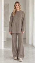 Front view of model wearing taupe ribbed knit two-piece lounge set with oversized top and wide-leg pants