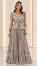 Full front view of slate grey sequin peplum evening gown with pleated skirt