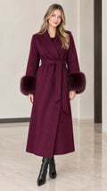 Full front view of model wearing burgundy maxi wrap coat with faux fur cuffs and tie belt