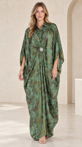 Front full view of woman wearing emerald green printed kaftan maxi dress with crystal brooch