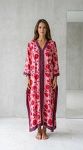 Front view of model wearing pink floral long kaftan maxi dress