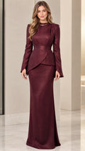 Front view of model wearing burgundy long sleeve asymmetrical peplum evening maxi gown