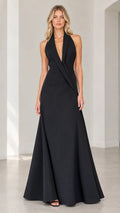 Front view of black halter tuxedo lapel backless evening gown on model
