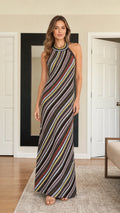Front view of model wearing black diagonal stripe halter neck maxi dress