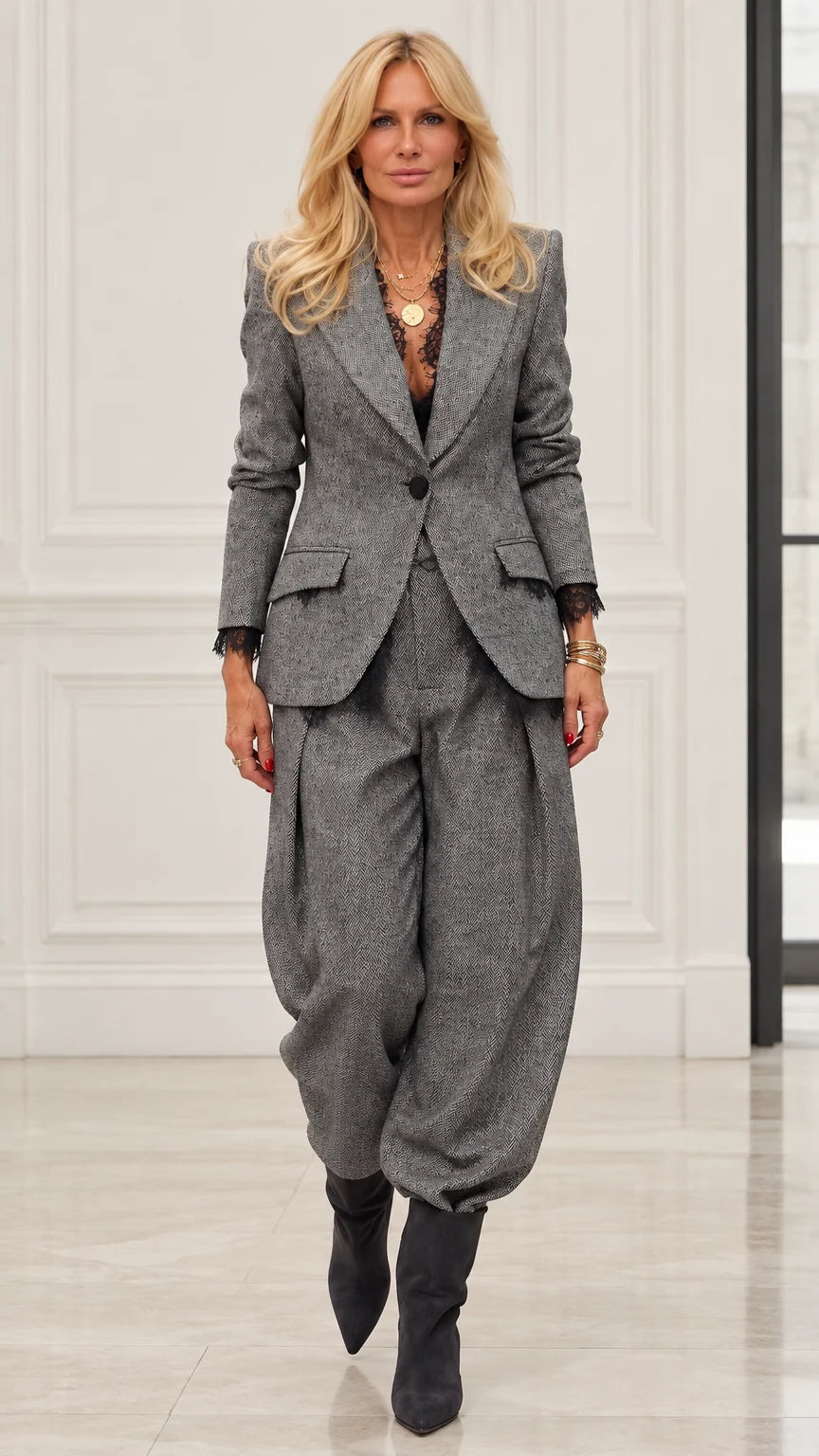 Model wearing Grey herringbone blazer and pleated balloon trousers two-piece suit set with lace cuffs