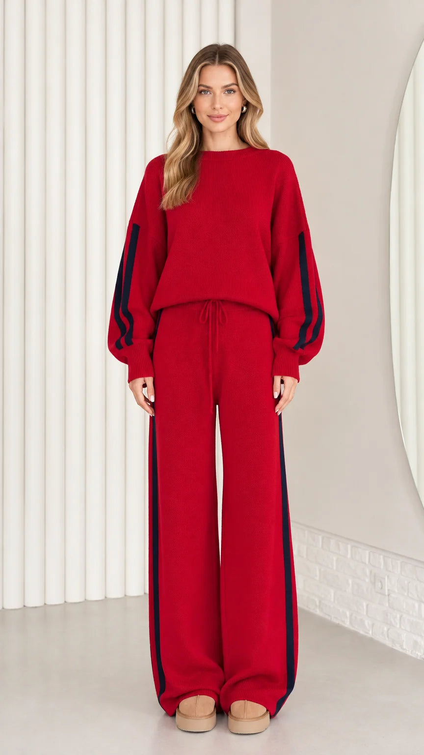 Front view of model wearing red knit two-piece lounge set with navy side stripes