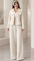 Full front view of model wearing the cream pearl-trimmed tweed jacket and matching wide-leg pants set