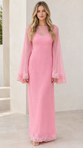 Front view of woman wearing pink sheer bell sleeve maxi dress with lace trim