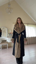 Front view of model wearing full-length Black faux fur trim belted coat