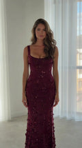 Front view of model wearing burgundy sequin floral mermaid evening gown with scoop neckline
