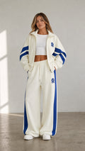 Women's cream two-piece tracksuit set with blue stripe accents front view