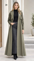 Front full-length view of model wearing olive green lace-sleeve maxi trench coat over turtleneck and denim skirt