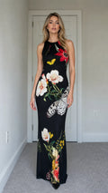 Model wearing black floral butterfly print sleeveless maxi dress from the front