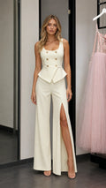 Front view of model wearing ivory peplum vest and wide leg pants set