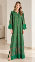 Model wearing an emerald green floral print kaftan maxi dress with fringed sleeves front view