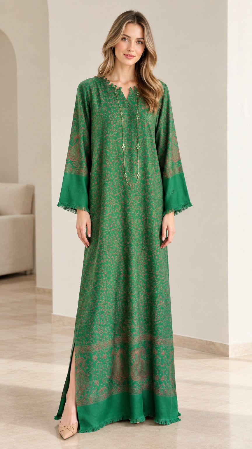 Model wearing an emerald green floral print kaftan maxi dress with fringed sleeves front view