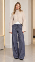 Women's beige high neck fuzzy knit cardigan front view with cutaway hem and wide leg pants