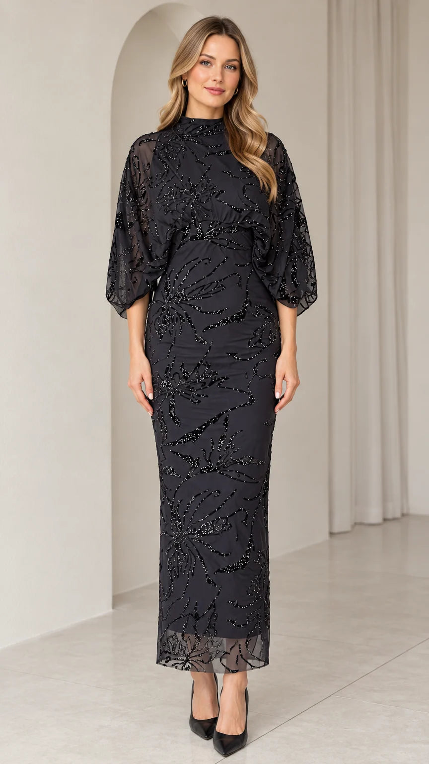 Front view of black mock neck beaded column evening dress with sheer dolman sleeves
