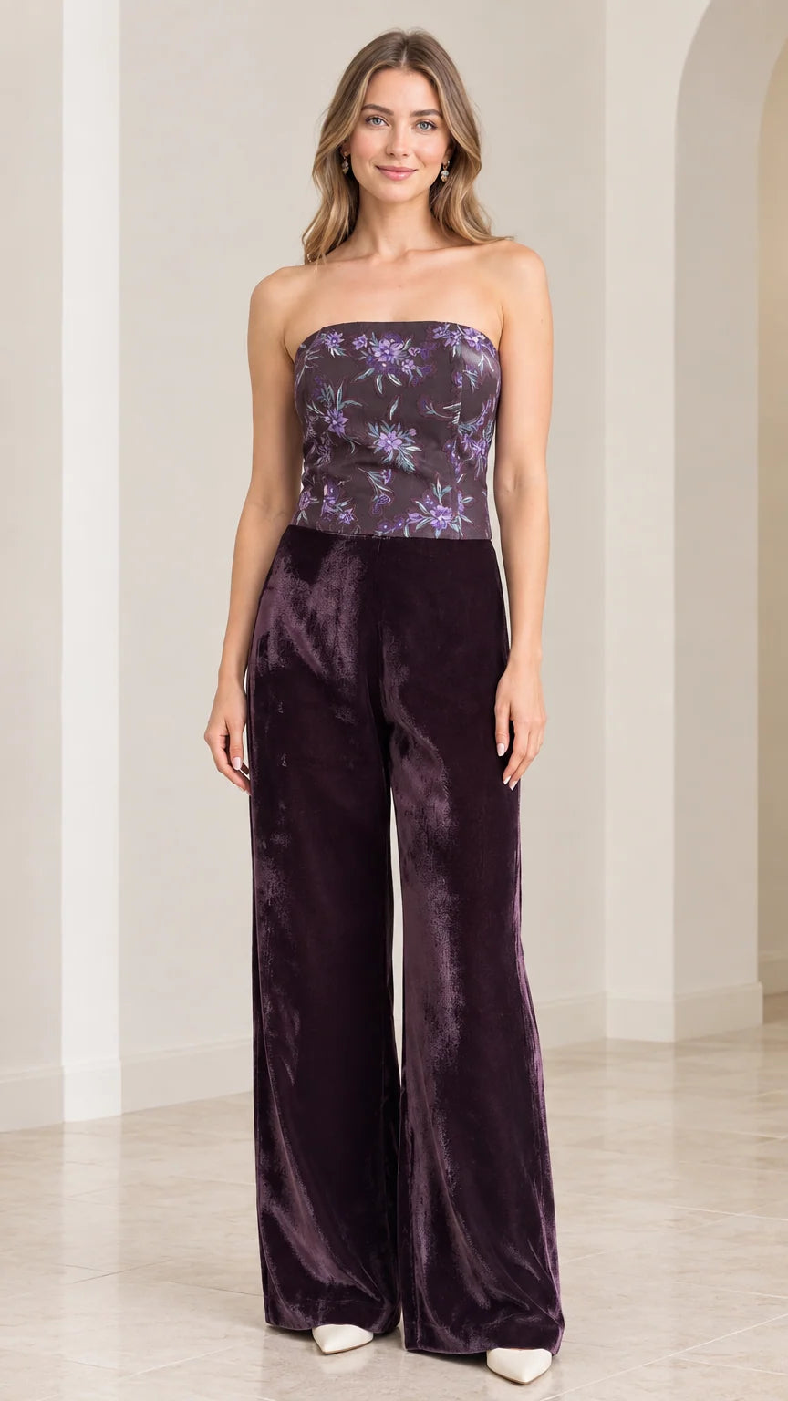 Front view of woman wearing strapless plum purple floral velvet wide leg jumpsuit