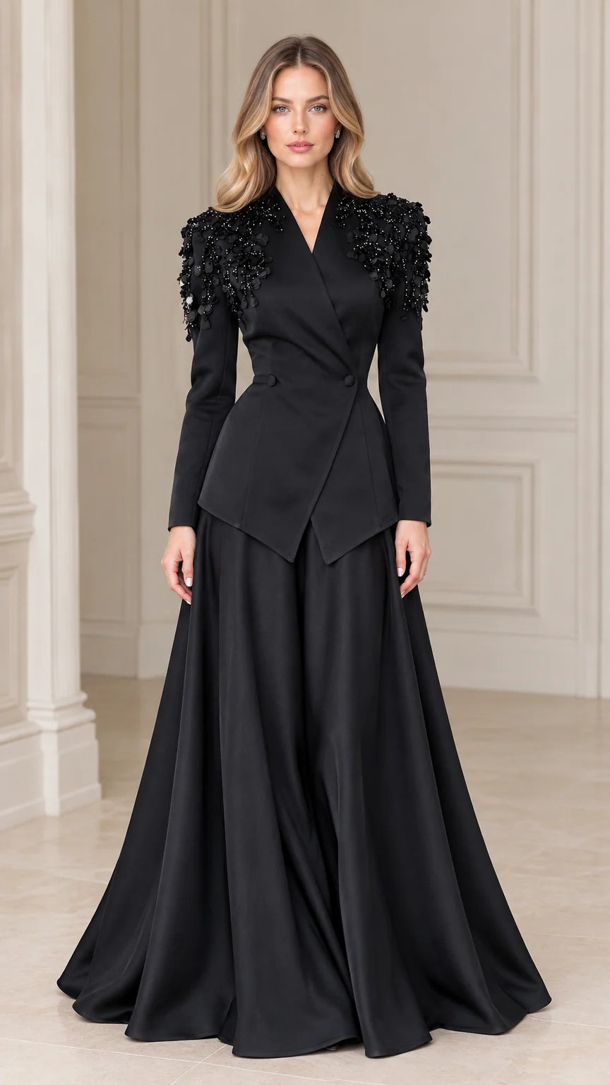 Front view of model wearing black embellished shoulder peplum blazer and maxi skirt two-piece evening set