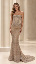 Front view of model wearing strapless beaded corset mermaid evening gown in champagne