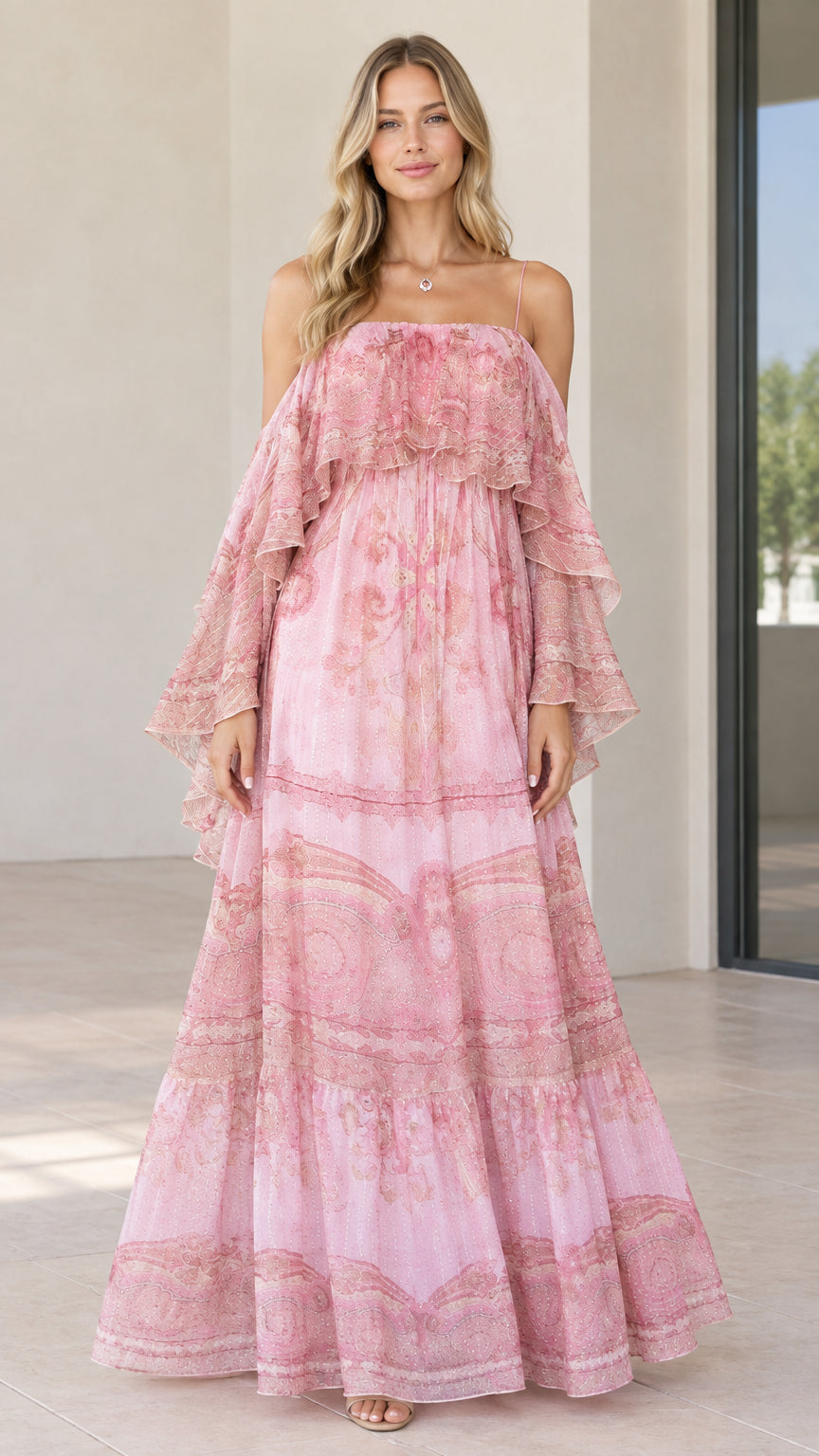 Front view of woman wearing pink paisley tiered cold-shoulder maxi dress