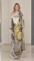 Front view of model wearing ivory one-shoulder celestial print kaftan maxi dress