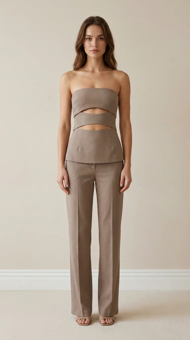 Front view of model wearing taupe strapless cut-out top and trousers set