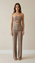 Front view of model wearing taupe strapless cut-out top and trousers set