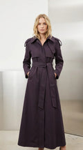 Front view of model wearing full-length deep purple belted maxi trench coat