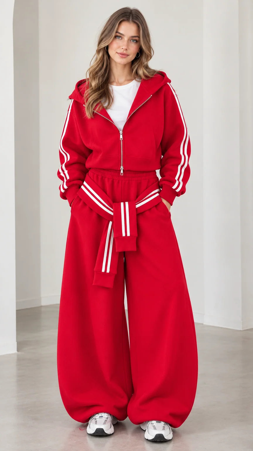 Model wearing red 2-piece cropped hoodie and baggy track pants set front view