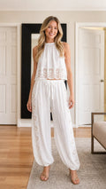 Model wearing white boho lace crop top and jogger pants set front view