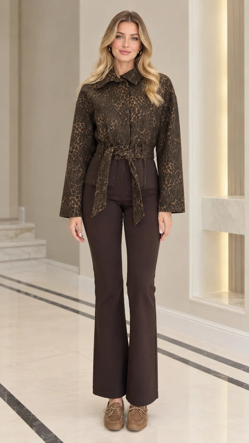 Full front view of model wearing coffee brown textured jacquard belted jacket with brown flare pants