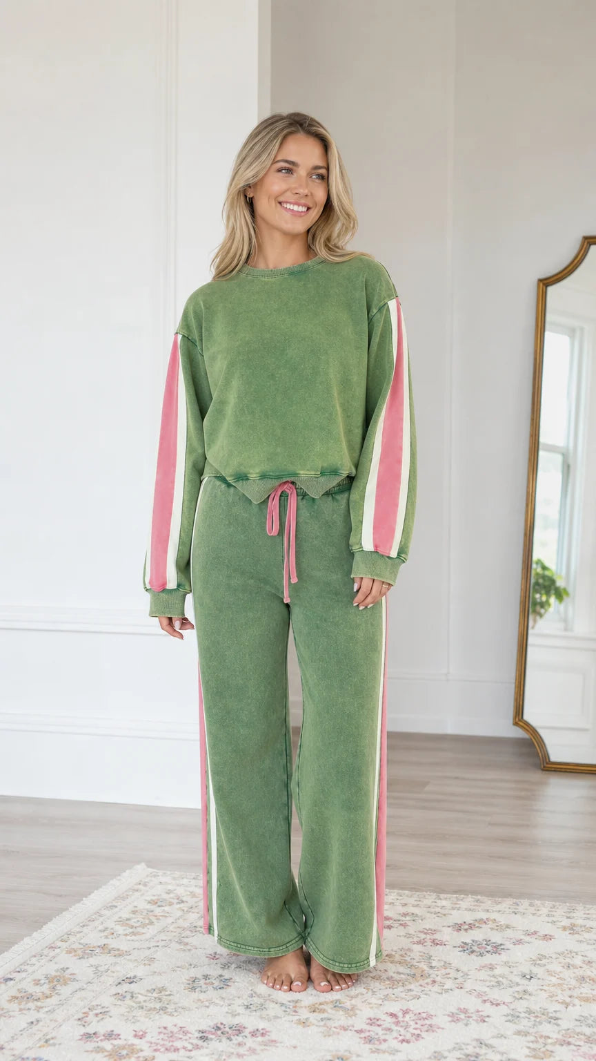 Front view of model wearing the Sage Green vintage washed sweatshirt and wide-leg sweatpants set with pink side stripes