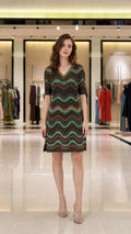 Front view of model wearing multi-color metallic wave knit dress