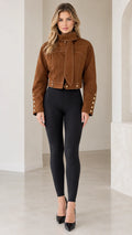 Front full view of woman wearing Caramel Brown cropped high-neck jacket with scarf tie and black leggings