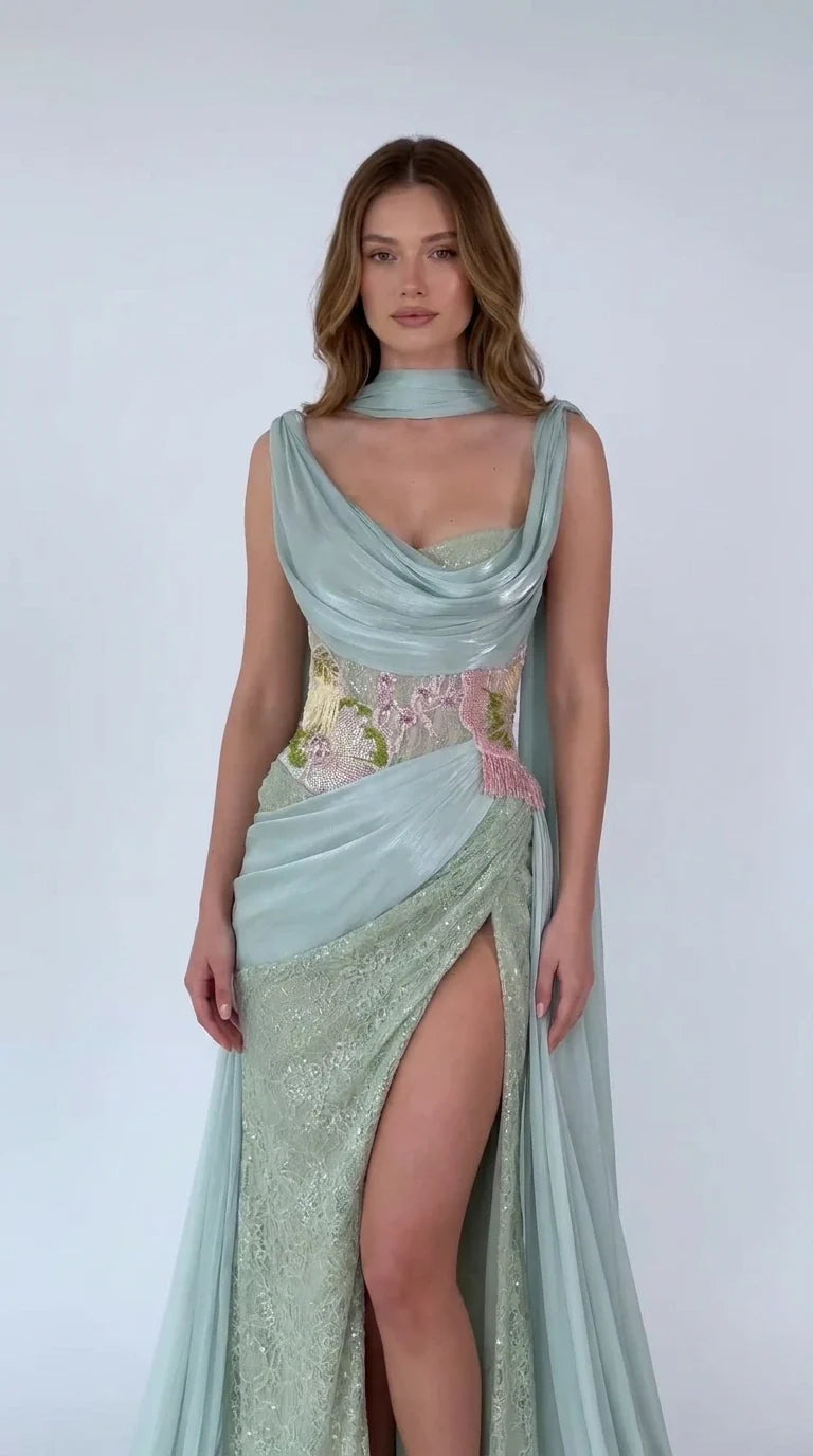 Front view of model wearing Sage Green draped cowl neck cape evening gown with slit