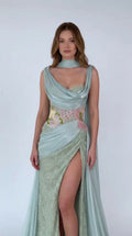 Front view of model wearing Sage Green draped cowl neck cape evening gown with slit