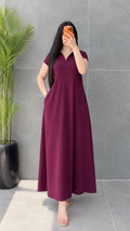 Front view of woman wearing Burgundy short sleeve polo collar maxi dress with hand in pocket