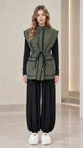 Front full view of woman wearing olive green monogram drawstring waist vest