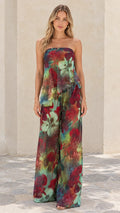 Front full view of woman wearing teal floral strapless tiered top and wide-leg pant set