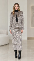 Full front view of model wearing Taupe Grey leopard print jacket and maxi skirt two-piece set with black boots