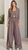 Front full view of woman wearing taupe 3-piece cropped jacket, crop top, and wide-leg pants set