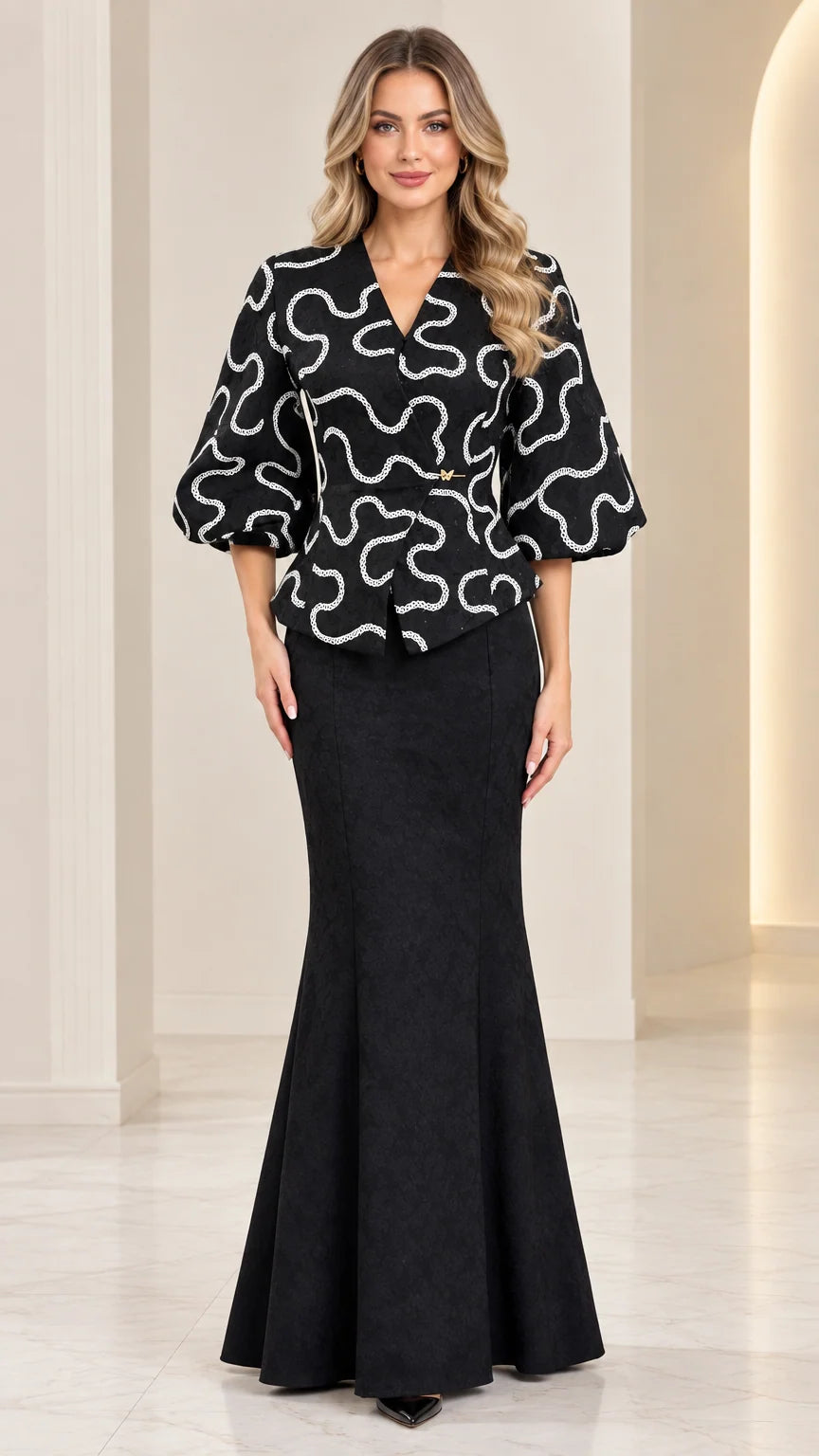 Full front view of model wearing black textured peplum top and mermaid maxi skirt set