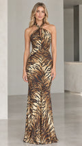 Front view of model wearing Bronze Gold halter neck shimmer animal print maxi gown